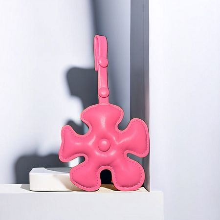 Creative Cartoon Flower Bag Charm (5 pcs) - A close-up of a pink puzzle piece-shaped bag charm made from PU leather, attached to a handbag.