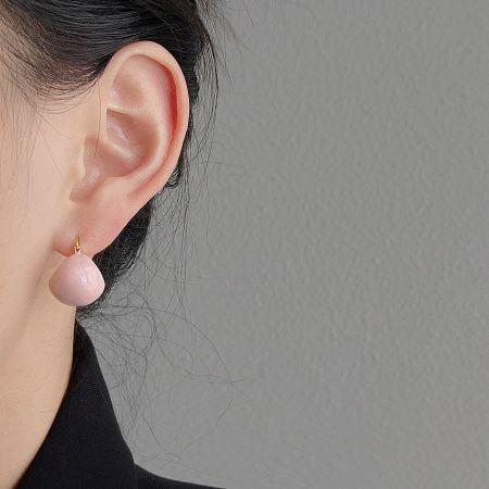 Model wearing the pink enamel gold-plated hoop earring to show scale and style.