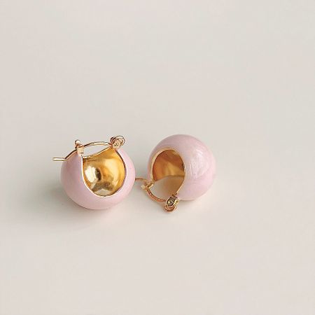 Another angle of the pink spherical earrings with elegant gold details.