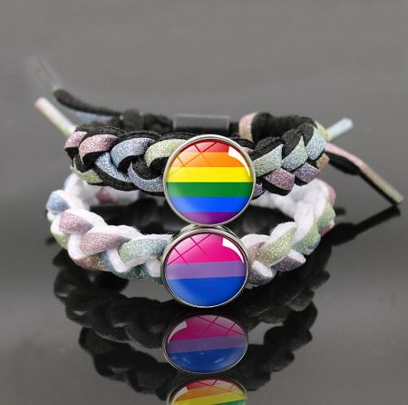 Two pride-themed bracelets displayed side-by-side, one with rainbow colors and the other with bisexual flag colors.