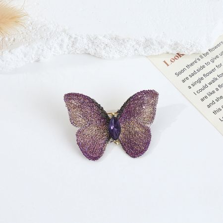 Metal Crochet Hand-Embroidered Fabric Butterfly Brooch (5 pcs) - A detailed close-up of the purple hand-embroidered fabric butterfly brooch, featuring intricate wing details and a sparkling central crystal.