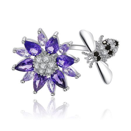 Spinning Purple Flower Ring displayed alongside a matching piece, highlighting the intricate purple and clear cubic zirconia details.