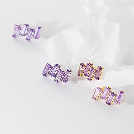Four pairs of sterling silver and gold-plated earrings with purple gemstones.