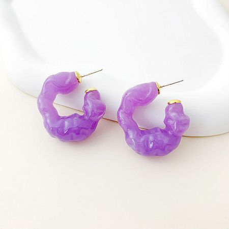 A pair of stylish purple irregular hoop earrings made from resin.