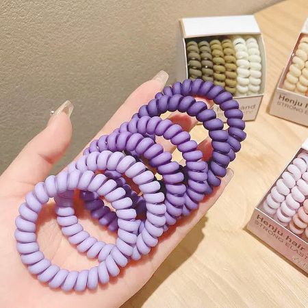 Vibrant purple spiral hair ties displayed.