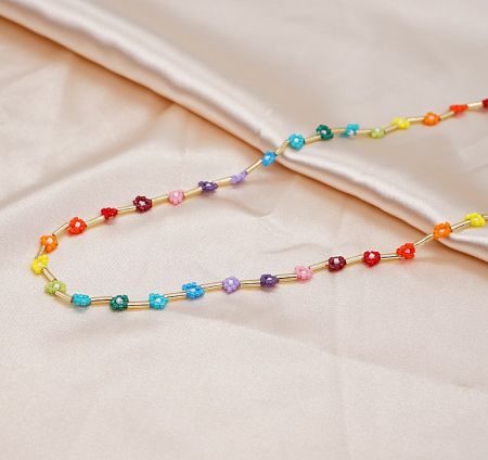 A vibrant rainbow-themed beaded necklace with a gold chain, perfect for summer wear.