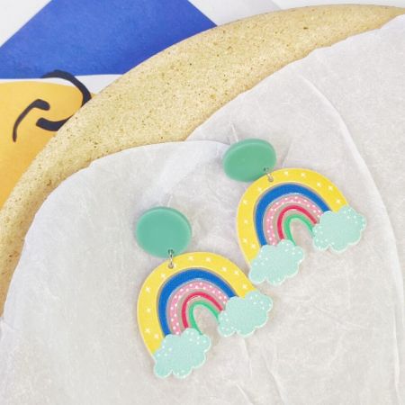 A pair of vibrant rainbow acrylic earrings on a clean white background.