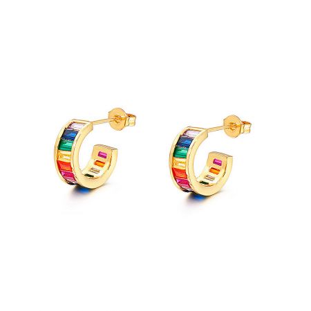 Close-up detail of the rainbow-colored gemstones on the gold hoop earrings.