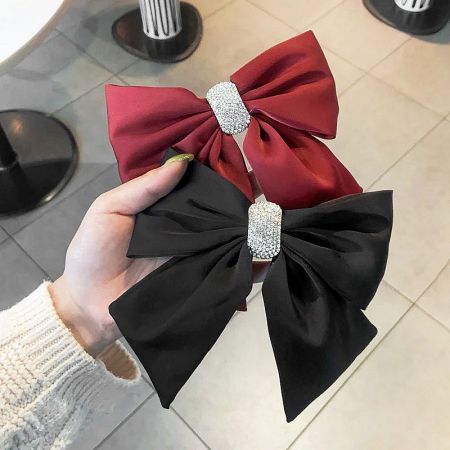 Top-down view of the red and black hair bows, showing their classic design and vibrant colors.