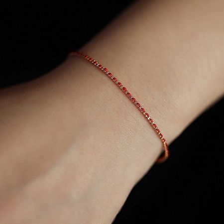 A model wearing the stylish red 925 sterling silver braided bracelet.