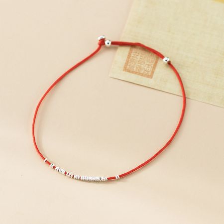 Close-up of the red string bracelet highlighting the detailed 925 sterling silver beads.