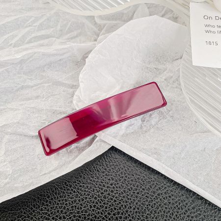A stylish solid red rectangle hair barrette clip.