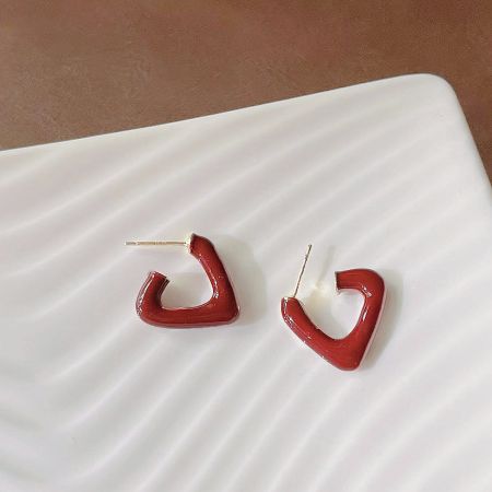 Front view of the red heart-shaped enamel earrings, showcasing the glossy finish.