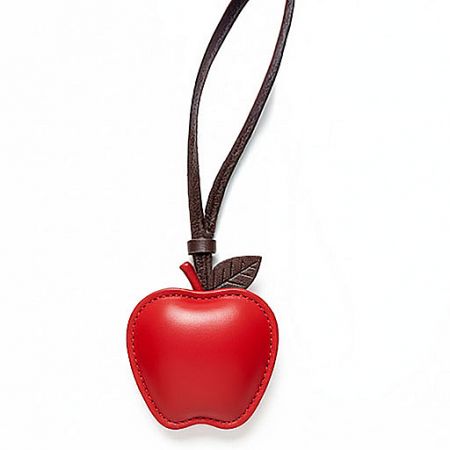 A classic red leather apple pendant on a simple brown cord.
