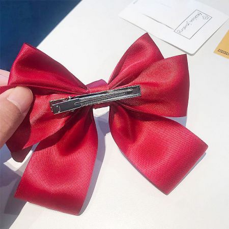 Back view of the red bow showing the alligator clip mechanism.