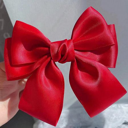 Detailed view of the red satin bow's construction.