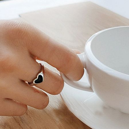 Lifestyle image of the silver-plated heart ring set next to a white teacup.