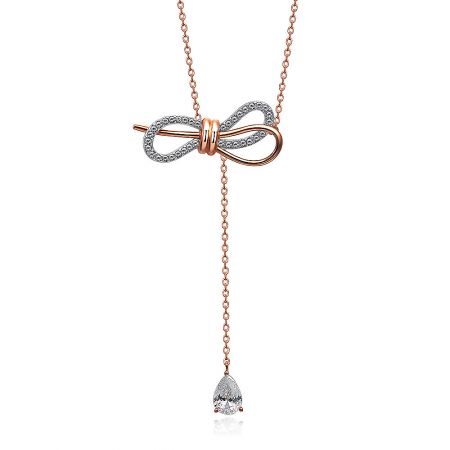Side view of the rose gold bow necklace highlighting the teardrop-shaped stone pendant.