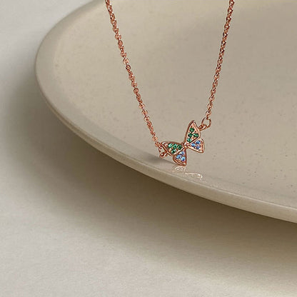 Detailed shot of the butterfly pendant with iridescent stones.