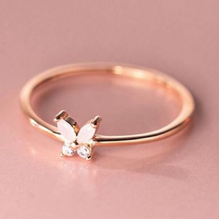 Detailed view of a rose gold butterfly ring with intricate gemstone detailing.