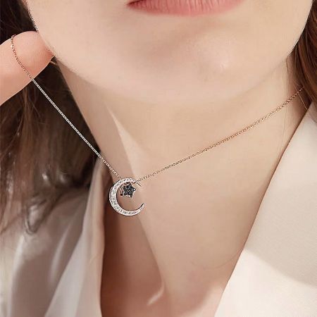 Minimalist style featuring the rose gold crescent moon pendant on its own.