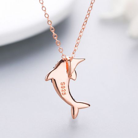 The back of the rose gold dolphin pendant, clearly marked with 'S925' to certify its sterling silver composition.