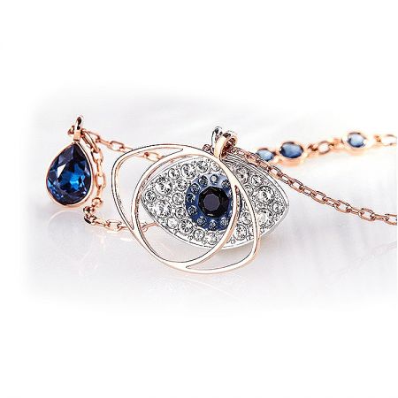 Angled shot of the rose gold Evil Eye pendant, emphasizing the sparkle of the high-quality gemstones.