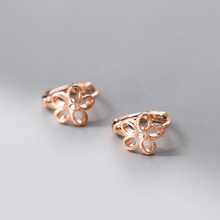 Close-up of the rose gold-plated flower earrings with a sparkling center.