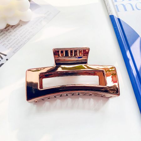 Detailed view of the rose gold metal hair banana claw clip.