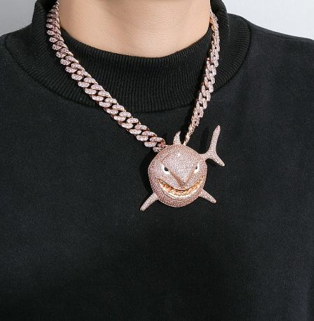 Detailed view of a custom rose gold hammerhead shark pendant, an example of unique hip hop jewelry designs.