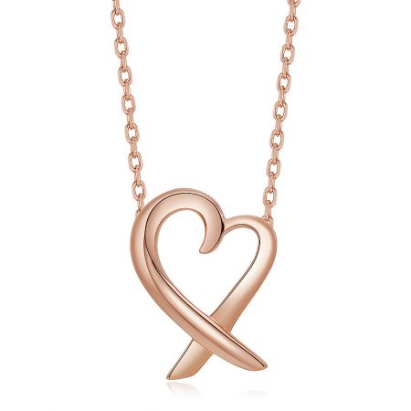 A detailed close-up of the polished rose gold heart pendant.