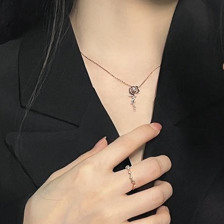 A beautiful rose gold necklace with a heart pendant, paired with a matching ring.