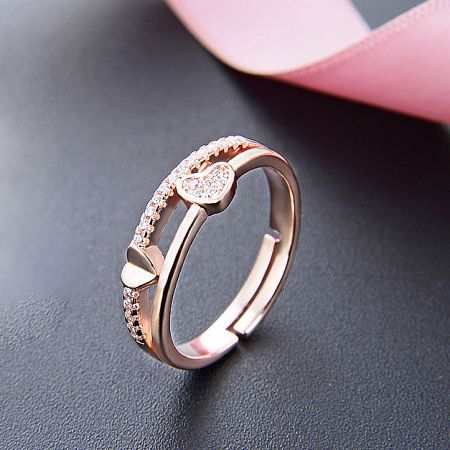 A single rose gold heart ring with brilliant diamond-like accents.