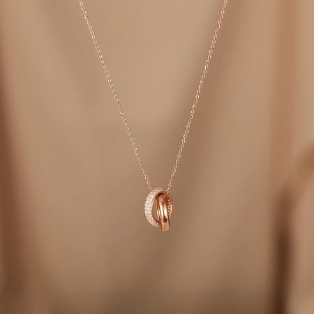 A detailed view of the Eternal Circles pendant, showing the fine craftsmanship and shimmering zircon stones.