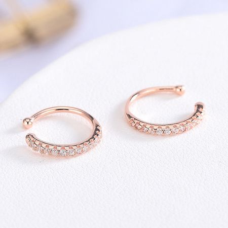 Elegant rose gold ear cuffs with brilliant diamond-like stones.