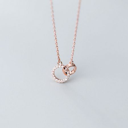 Detailed shot of the rose gold interlocking circle pendant necklace, showcasing its warm tone and craftsmanship.