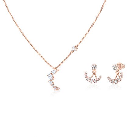 Detailed view of the rose gold moon and star necklace and earrings set.