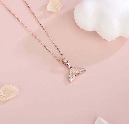 Close-up of the rose gold mermaid tail necklace pendant, highlighting the sparkling cubic zirconia stones.