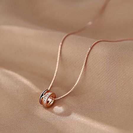 A stylish rose gold choker from the set, featuring a unique crisscross pendant design.