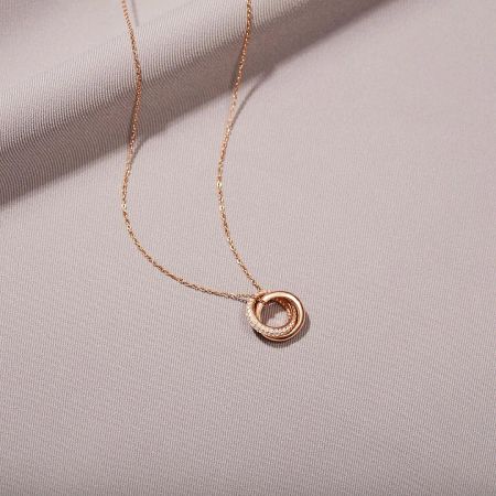 Romantic rose-gold version of the Eternal Circles double zircon necklace, highlighting its warm tone.