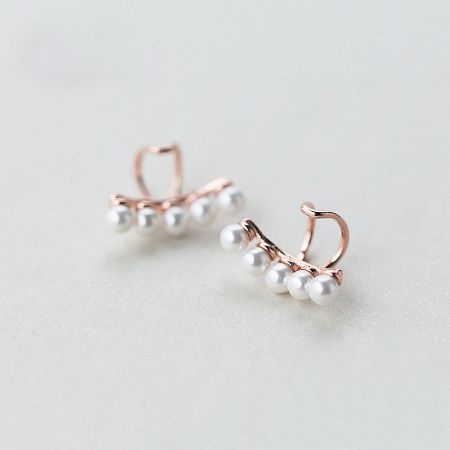 Detailed shot of the elegant rose gold plated pearl ear cuff.