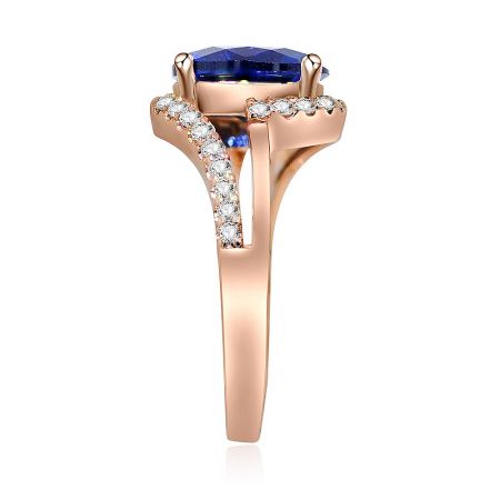 Side profile of the rose gold ring, highlighting the deep blue gemstone and the delicate diamond accents along the band.