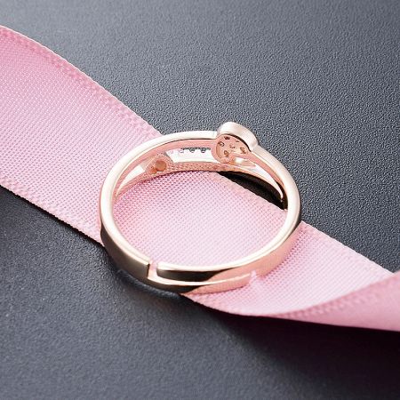 The adjustable opening ring design demonstrated with a pink strap.