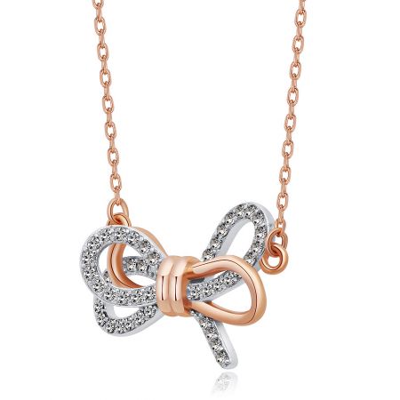 Detailed view of the two-tone rose gold and silver bow pendant with sparkling diamond-like cubic zirconia.