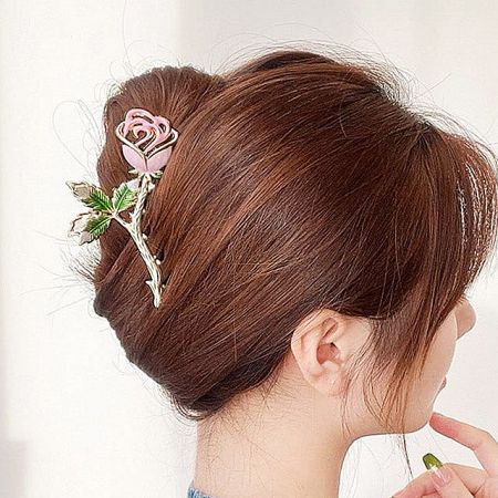 A model showcasing the elegant rose hair clip in a stylish updo hairstyle.