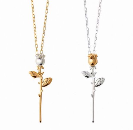 Two variations of the rose-shaped necklace, one in gold and one in silver.