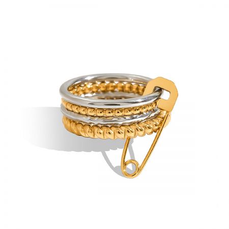 Stackable Gold and Silver Ring Set with Safety Pin Charm - A close-up of a unique stackable ring set featuring a gold and silver design with a prominent safety pin charm, made from non-tarnish stainless steel.