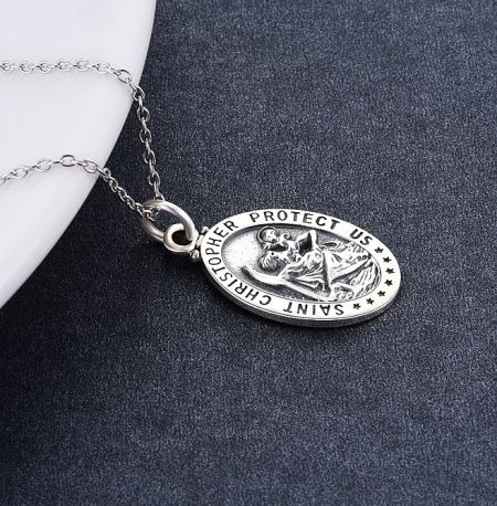 Reverse side of the Saint Christopher pendant with the inscription 'PROTECT US'.