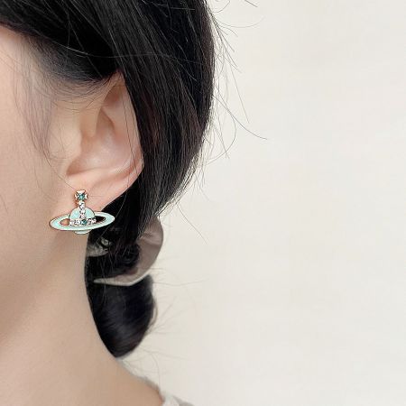 Model wearing the Saturn-shaped planet stud earring, showcasing its size and style.