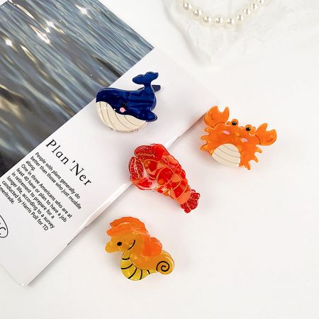 Colorful sea creature hair clips including a whale, lobster, seahorse, and crab.